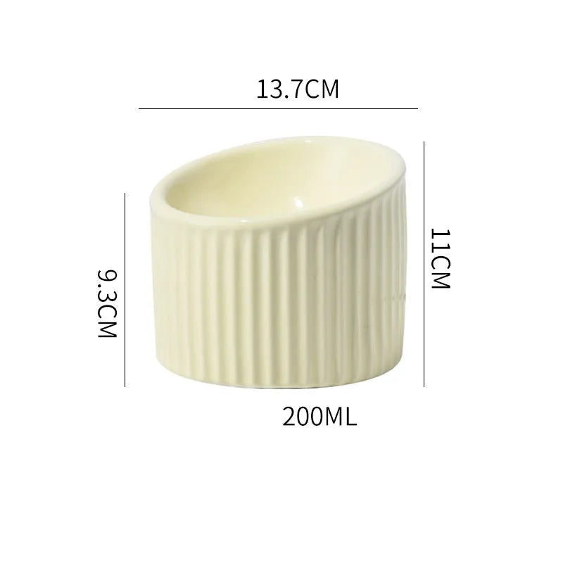 Dark green ceramic elevated cat bowl with tilted, round design for food or water.