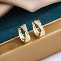 Copper geometric drop earrings with zircon detailing in 14K yellow finish
