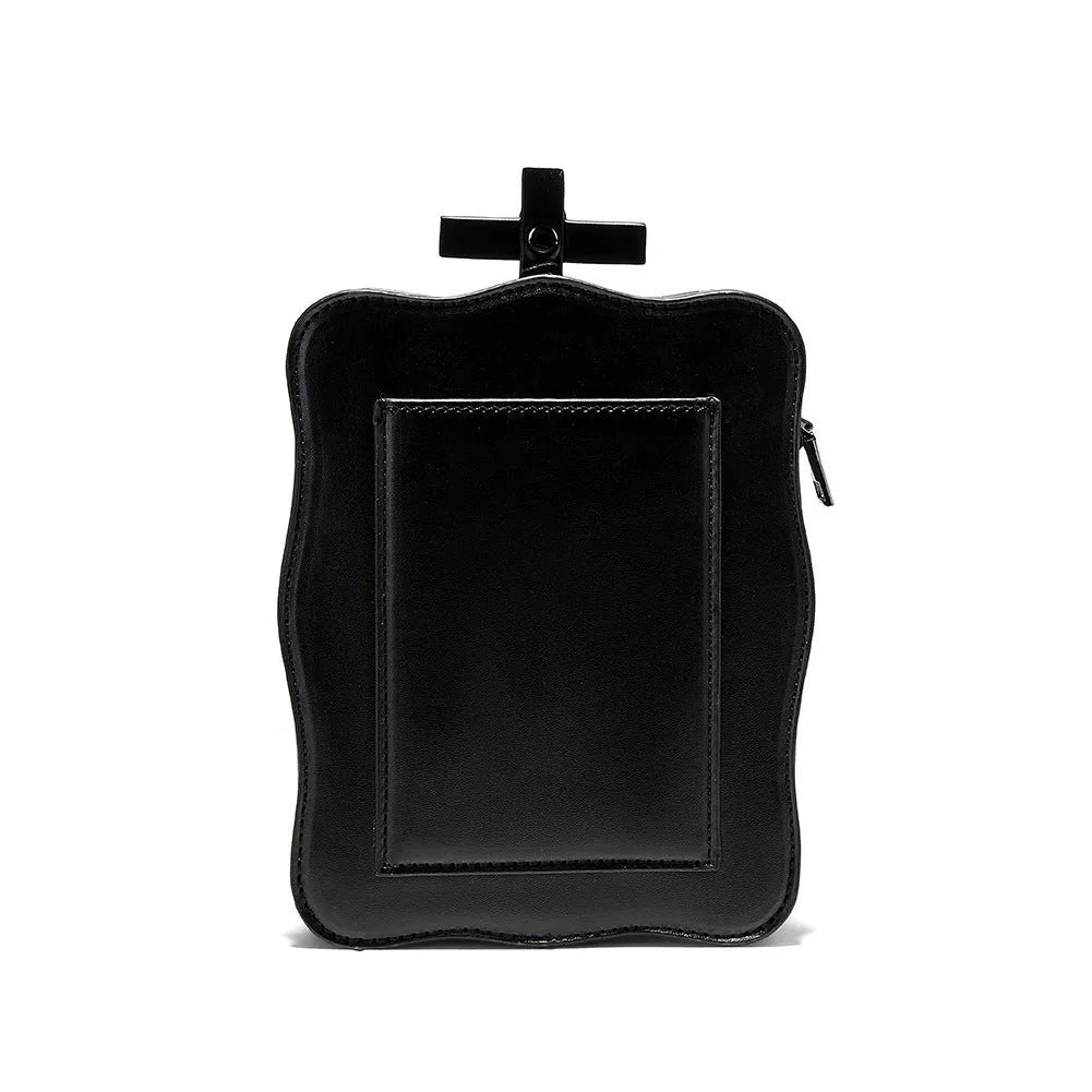 Black mini square crossbody bag with embossed skull design, decorative stitching, rivets, and chain details.