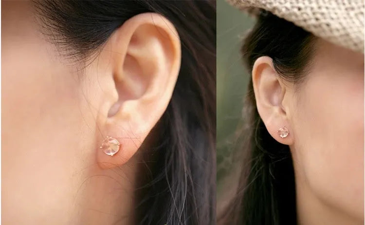 Rose gold coloured drop shape stud earrings with crystal inlay on silver base.