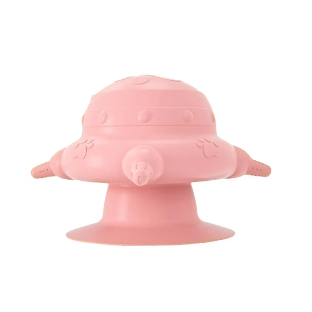 Pink silicone pet nursing milk bowl with four attached pacifiers on a flat base.