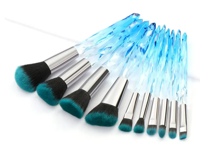 Ten crystal-handled foundation brushes with artificial fibre bristles in black, blue, red, and yellow.