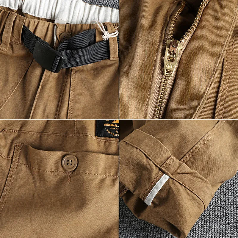 Men's khaki cotton work trousers with N buckle belt on a mid waist, showing three-dimensional cut.