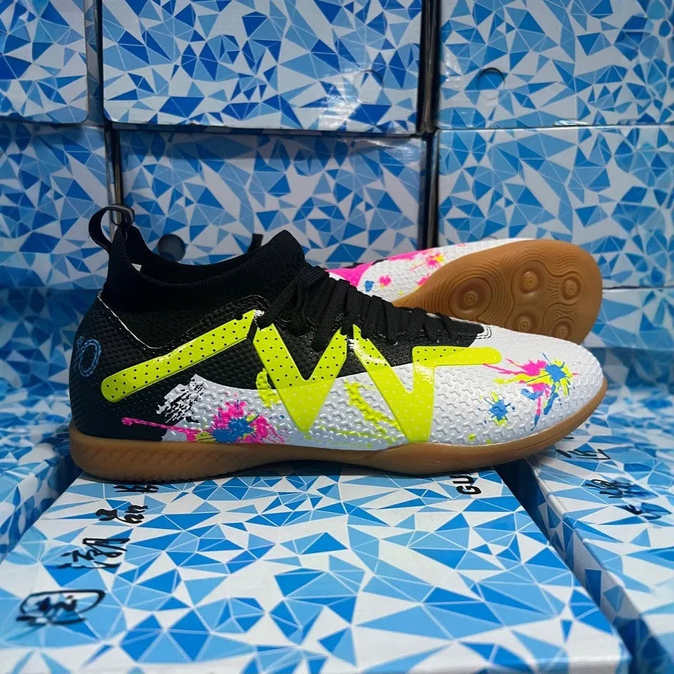 Low-top soccer shoes with broken spike nails on non-slip rubber outsole in black and yellow colourway