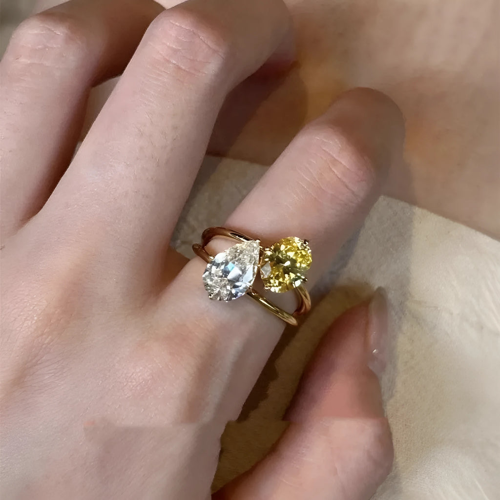 Copper women's ring with geometric open design and water drop shaped zircon stones in a contrast colour.