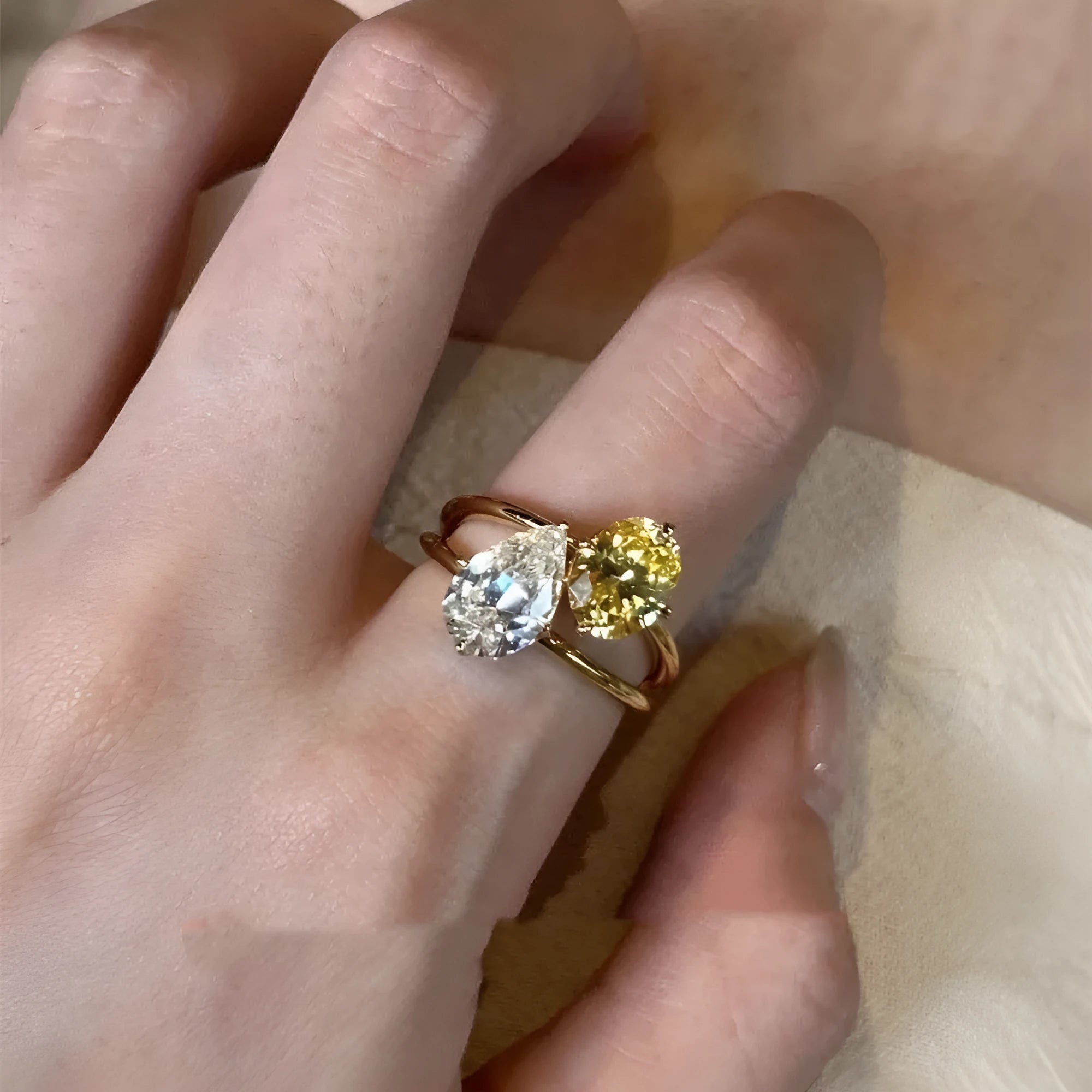 Copper women's ring with geometric open design and water drop shaped zircon stones in a contrast colour.