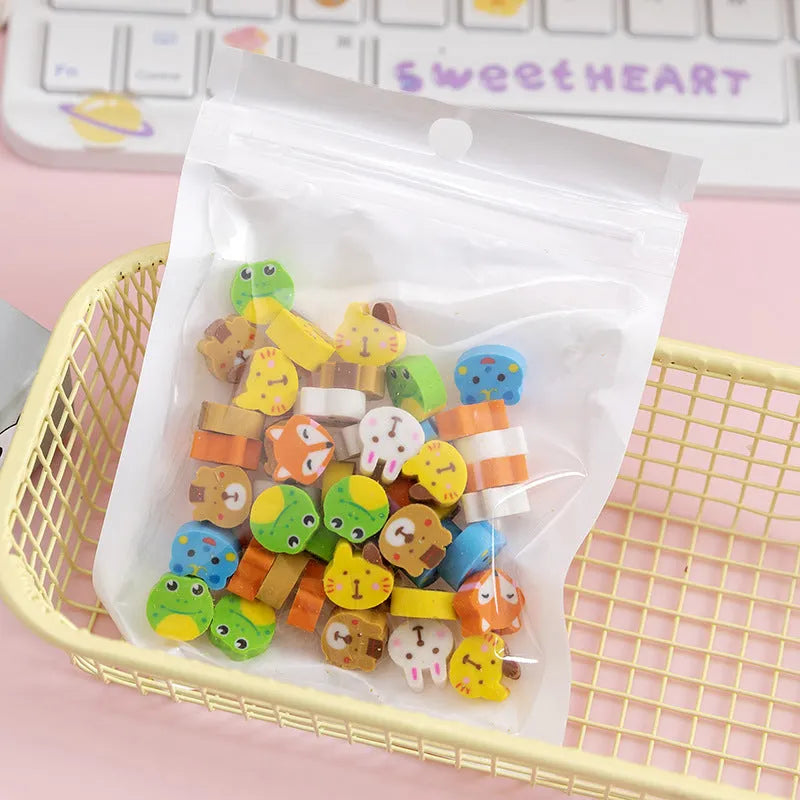 50 small colourful cartoon erasers in a pearlescent bag showing fruit, animal, cake, and Halloween themes.