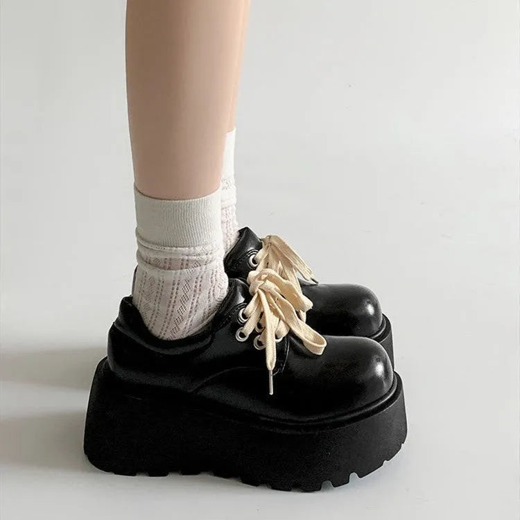 Women's matte black lace-up high heel shoes with a thick rubber sole and round toe.