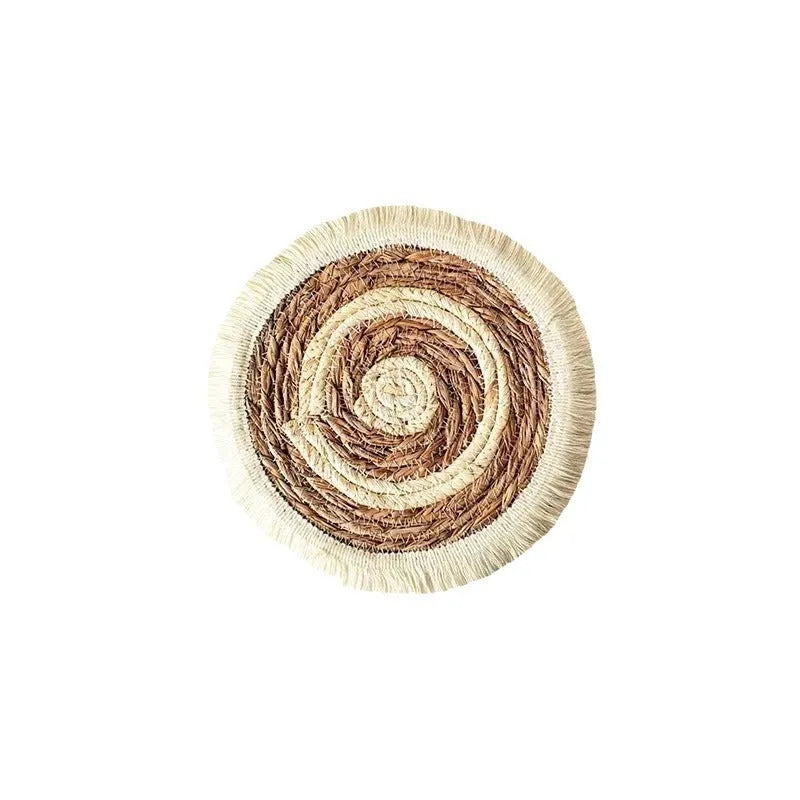 Round natural papyrus placemat with decorative tassels on a wooden table, shown in various sizes.