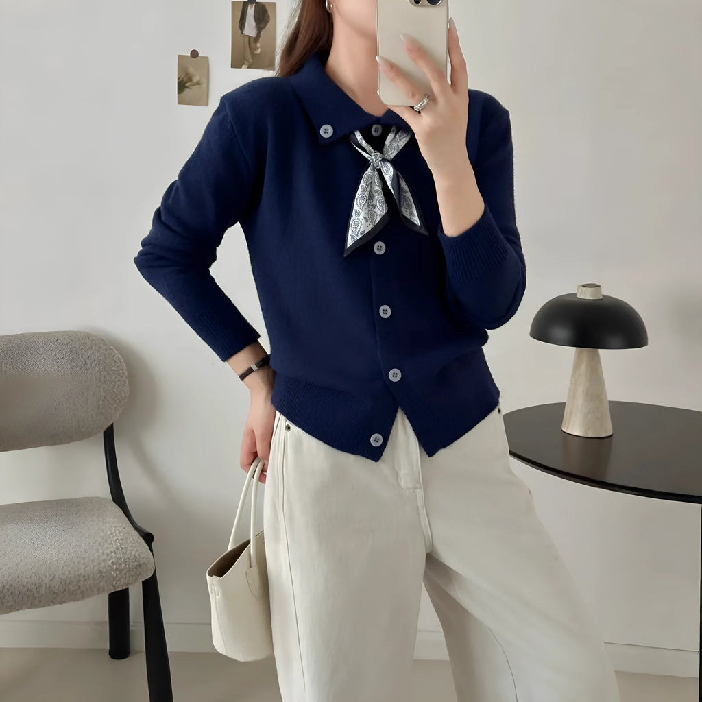 Beige cardigan sweater with a built-in lapel scarf and long sleeves laid flat