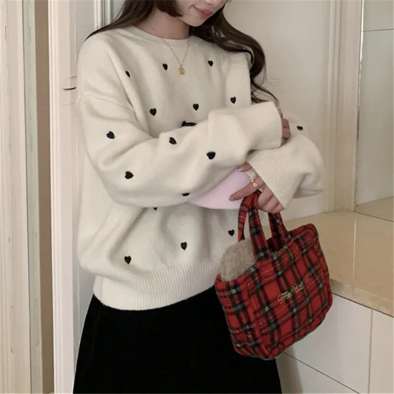 Women's loose fit cream pullover sweater with love heart embroidery detail on the front