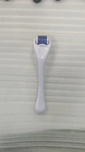 Black handle micro needle roller with purple wheel showing 540 stainless steel needles for dermaplaning