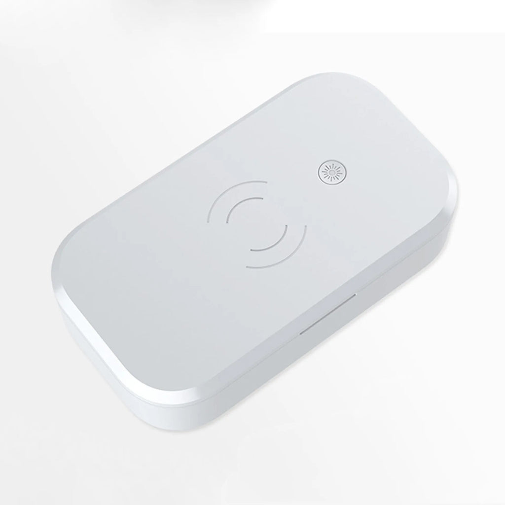 White ultraviolet disinfection box for nail tools with built-in wireless phone charging pad.