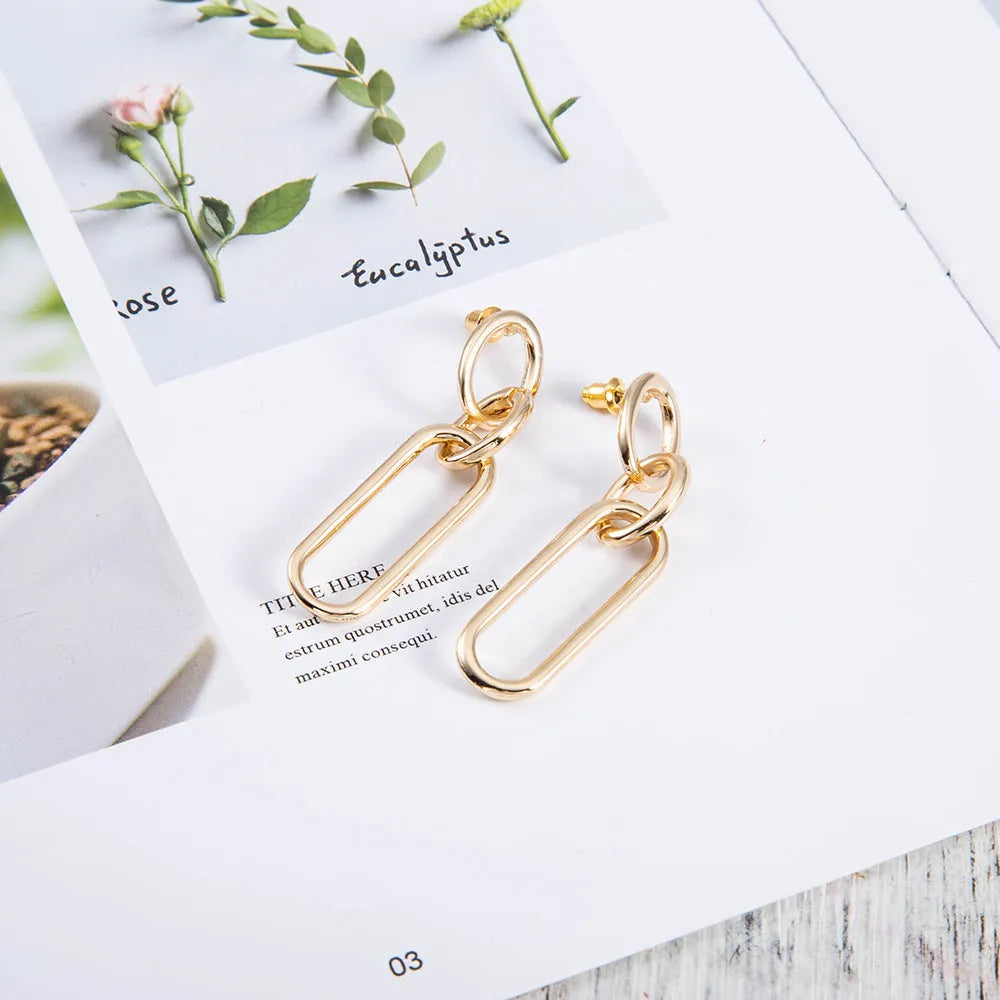 Geometric sterling silver tone hoop earrings for women with a ring and line design.