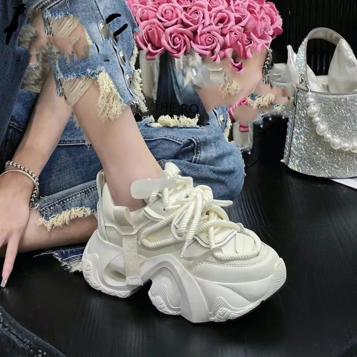 Women's creamy white casual sneakers with cross-strap detail and a built-in wedge heel on a synthetic leather and EVA sole.