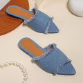 Women's flat denim slippers with tassel detail in apricot colour on a white background