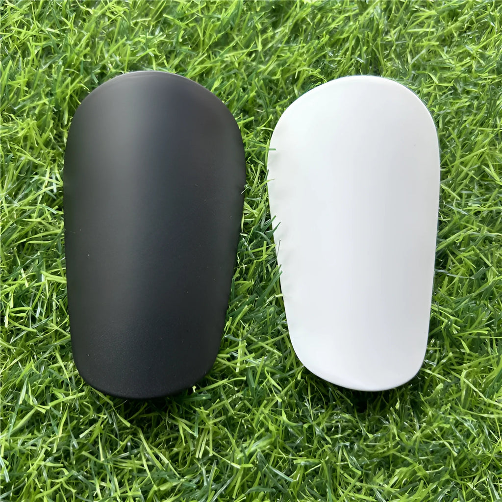 Extra small 8x5cm plastic football shin guards in black and white colours