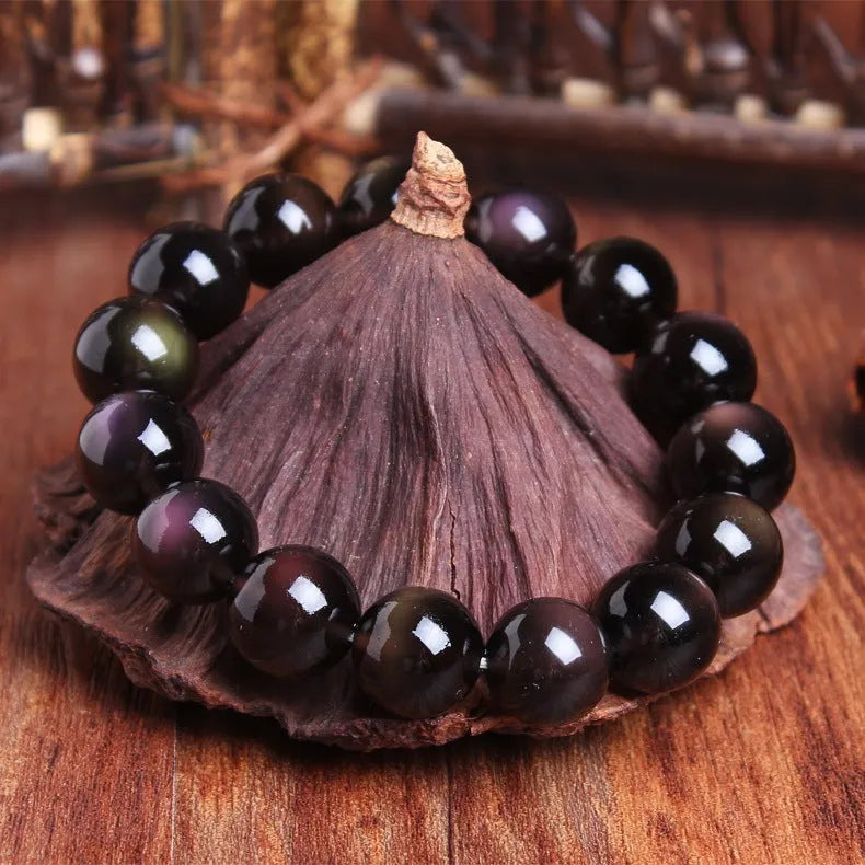 Natural crystal bracelet with a Pi Xiu charm and icy obsidian beads in geometric ethnic style.
