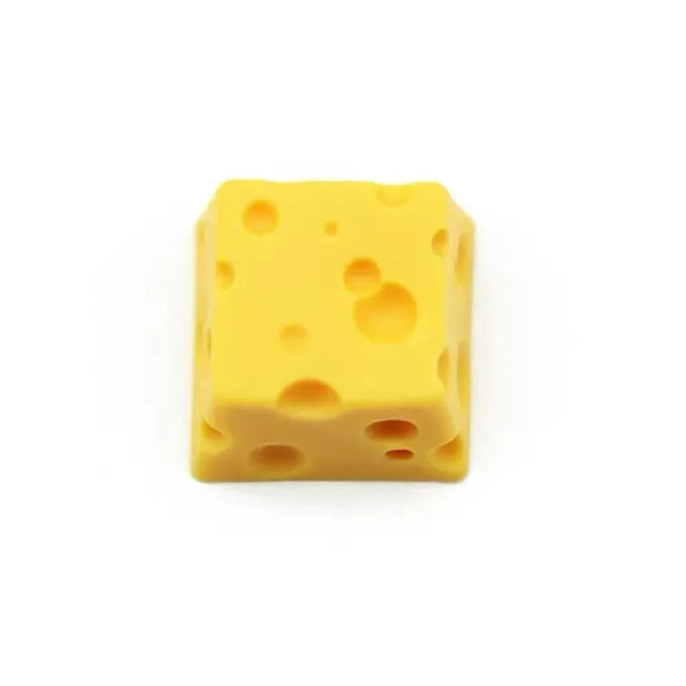 Yellow resin mechanical keyboard keycap shaped like a cheese wedge with a cute character face.