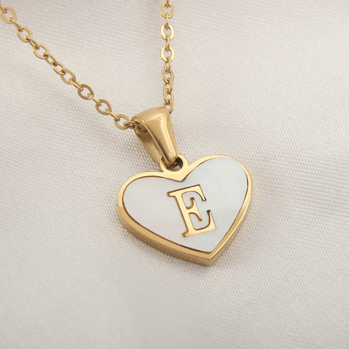 Gold plated heart-shaped personalised necklace with white shell charm on an adjustable chain.