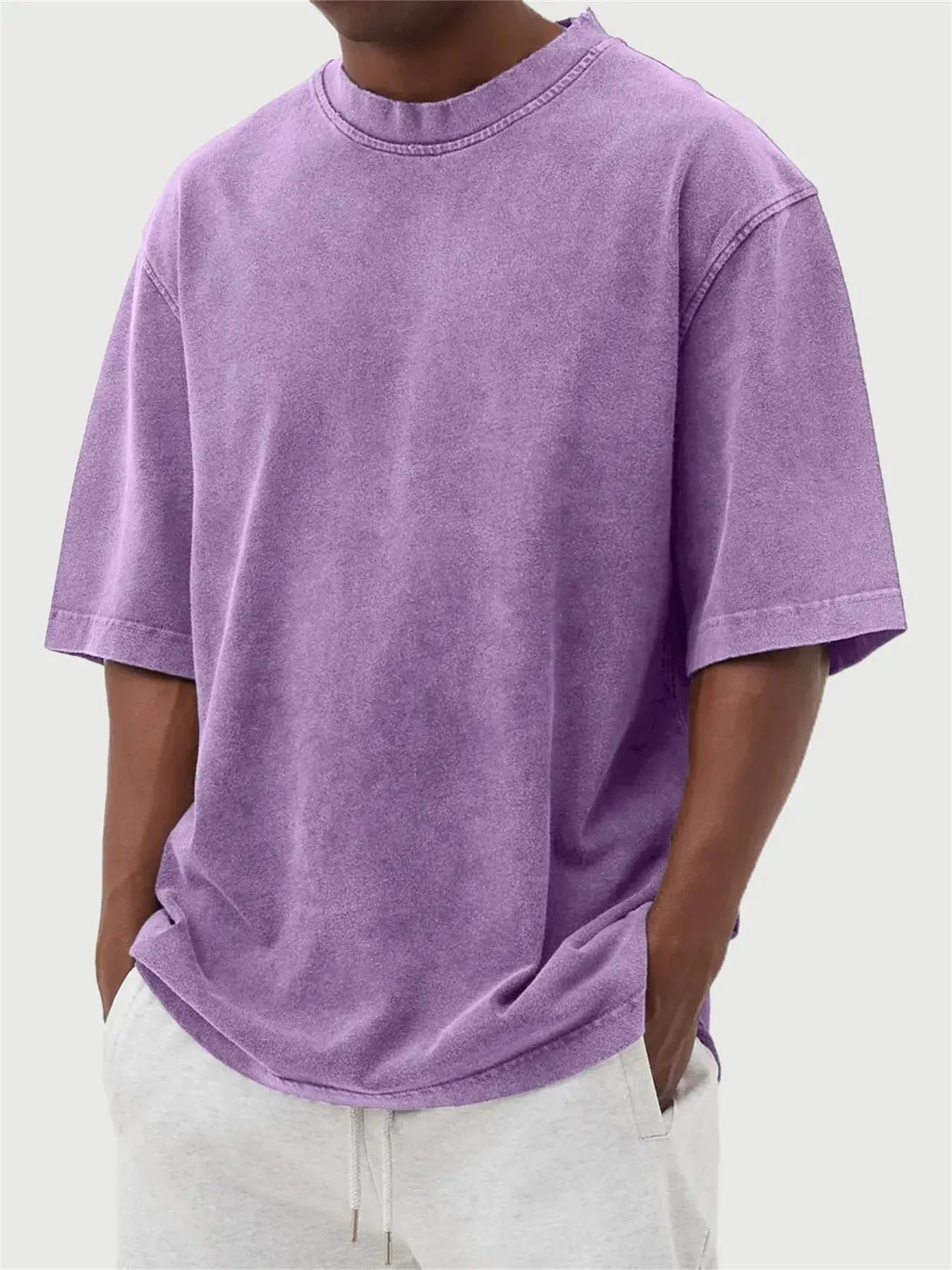Men's loose-fit stone-washed t-shirt in army green showing distressed texture and pullover style.