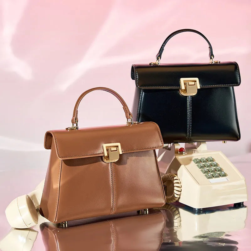 Women's black genuine leather shoulder bag with vachette clasp closure showing horizontal square design