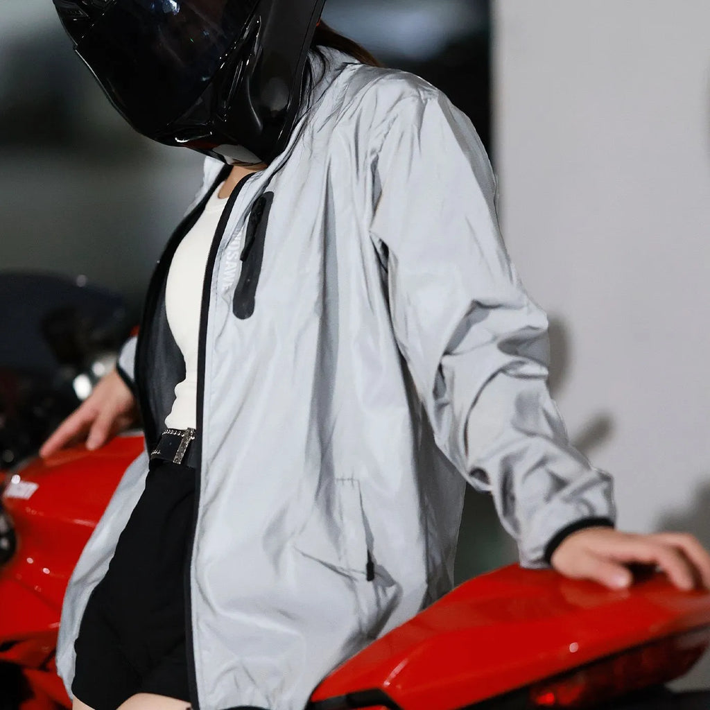 Silver waterproof polyester long sleeved top shown on a hanger.