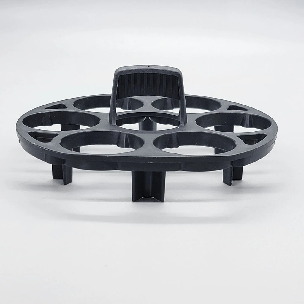 Black plastic egg holder basket on a kitchen countertop, showing its 13.8 cm length and retainer design.