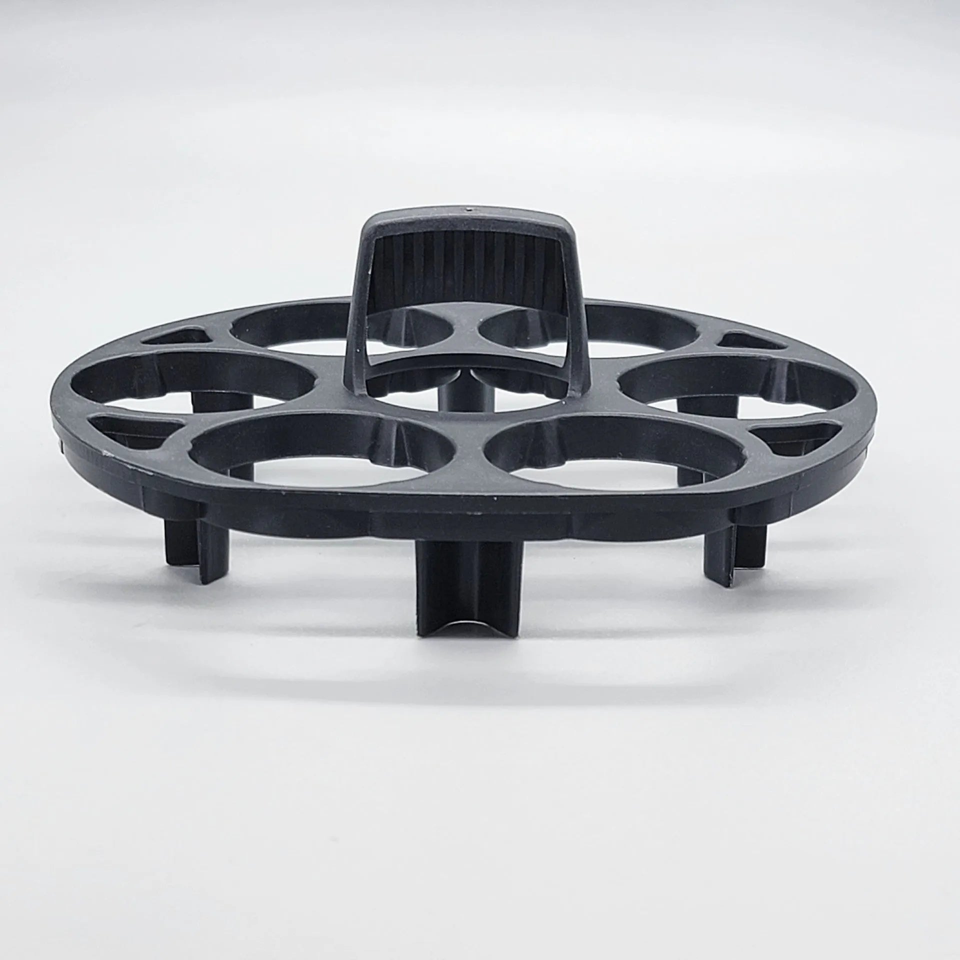 Black plastic egg holder basket on a kitchen countertop, showing its 13.8 cm length and retainer design.