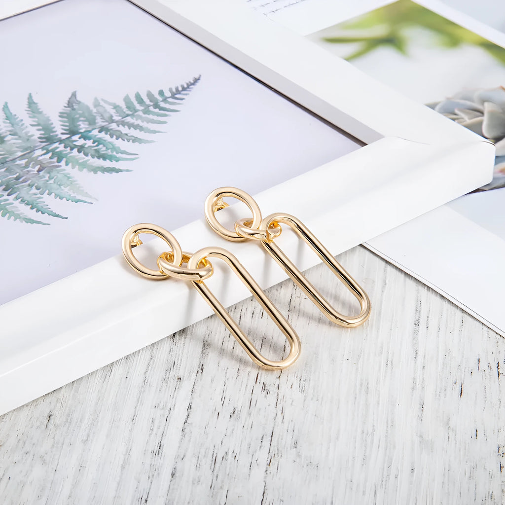 Geometric sterling silver tone hoop earrings for women with a ring and line design.