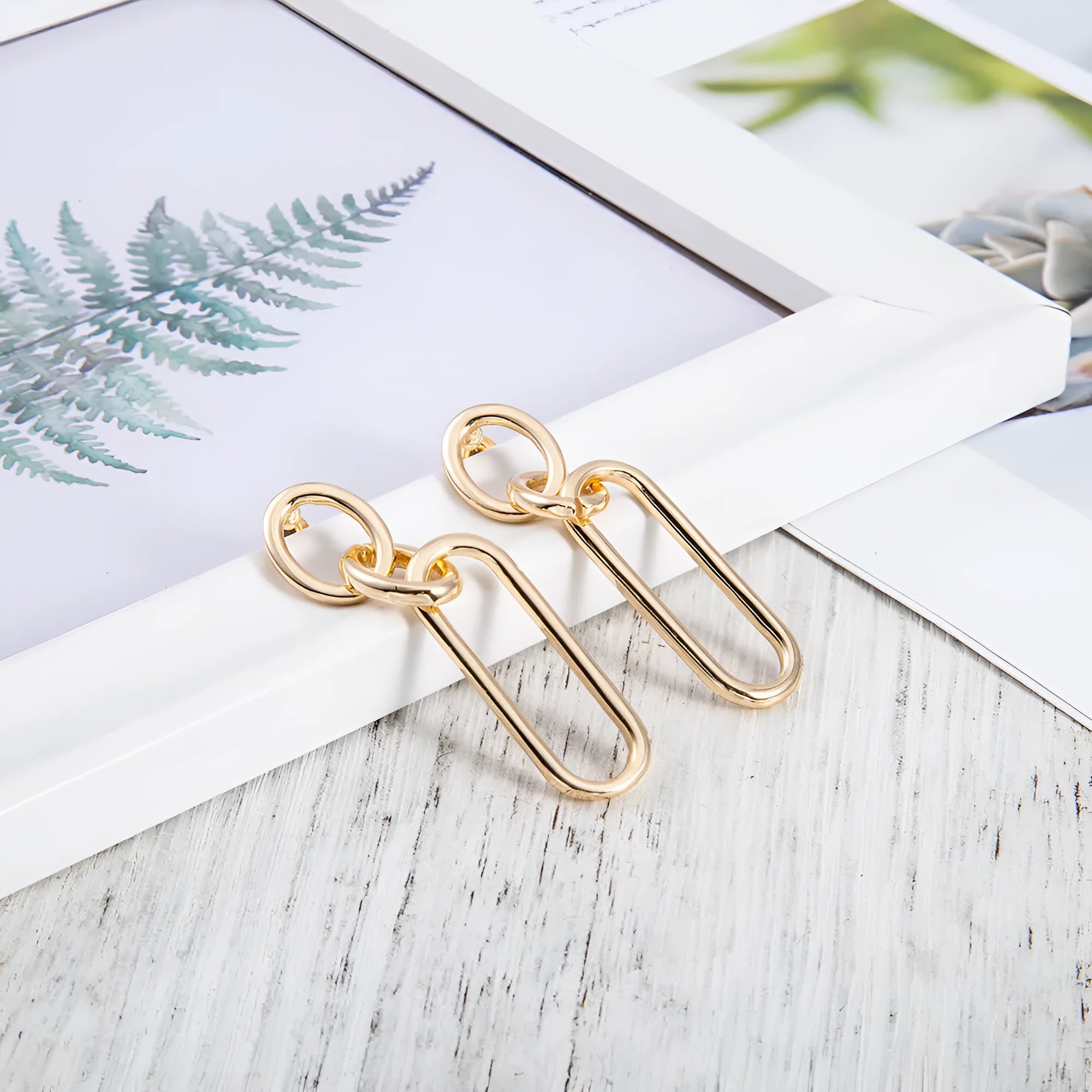 Geometric sterling silver tone hoop earrings for women with a ring and line design.