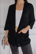 Women's thin waffle weave cardigan coat in army green with pockets, shown on a hanger.