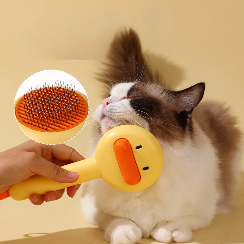 Small yellow duck-shaped pet grooming comb with needle pins for cats and small dogs