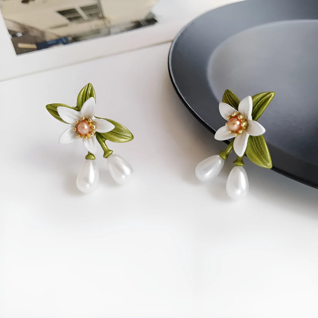 Alloy camellia flower earrings with sterling silver needle and contrasting colours including stud and clip options