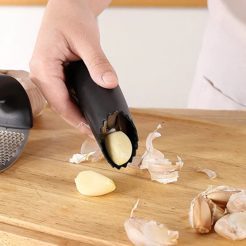 304 stainless steel garlic press in black, blue, green, and pink colour options on a kitchen counter