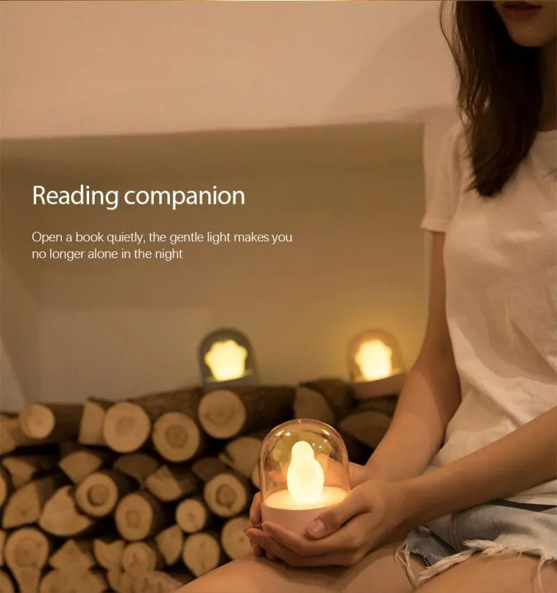 Grey cat paw shaped USB rechargeable night light with rotating musical display