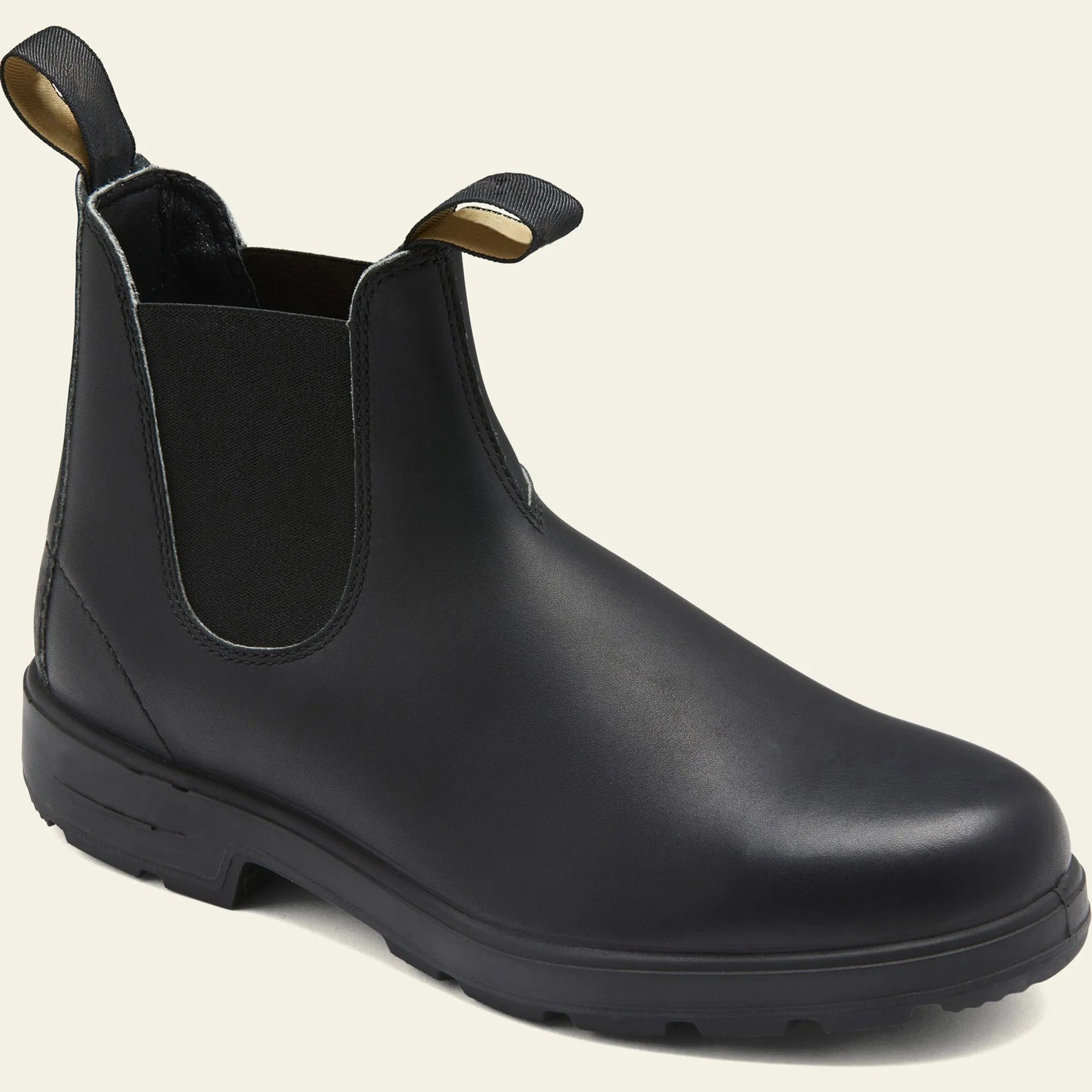 Vintage frosted brown leather Chelsea boot with round toe and low heel on a wooden surface.