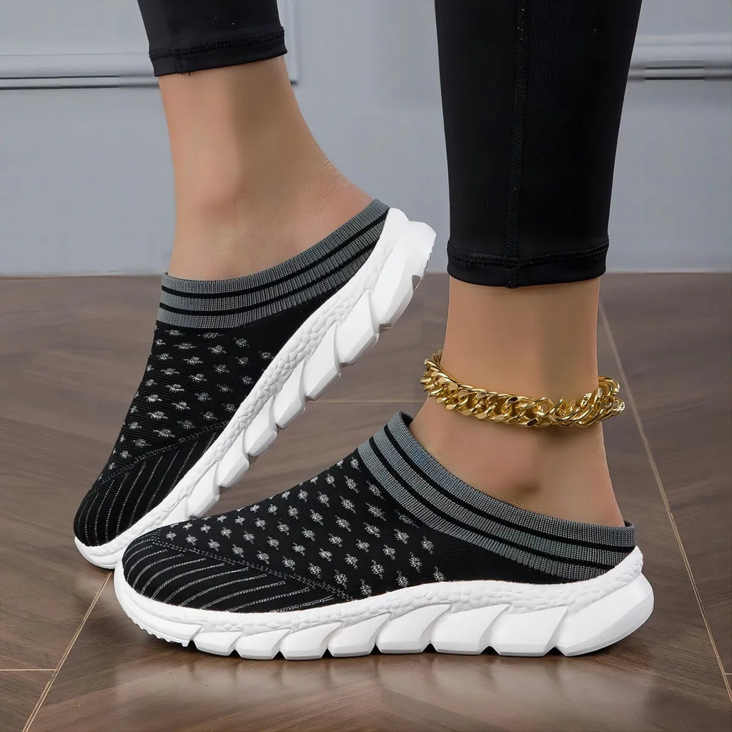 Women's black Flyknit slipper shoes with striped pattern and hollowed-out design on a viscose sole.