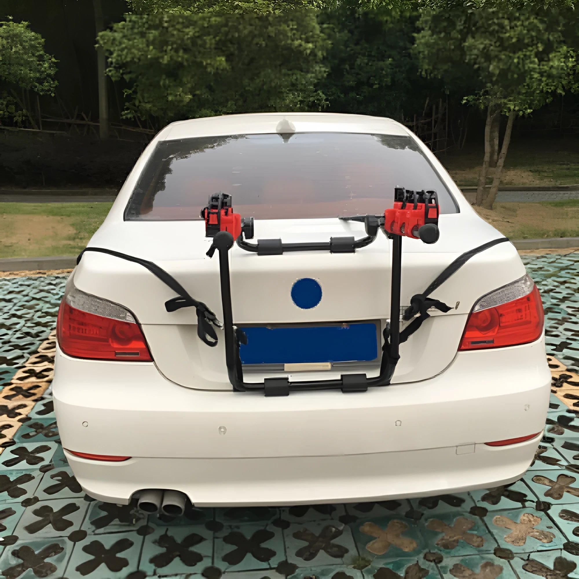 Black and red trunk-mounted car bike rack showing pull belt and tie rope fastening options