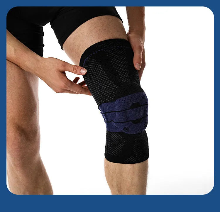 Adult sports knee pads in black and blue colour, shown on a knee for size reference.