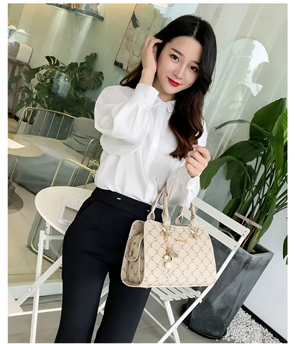 Women's geometric print PU leather messenger bag with internal organisers and zip closure.