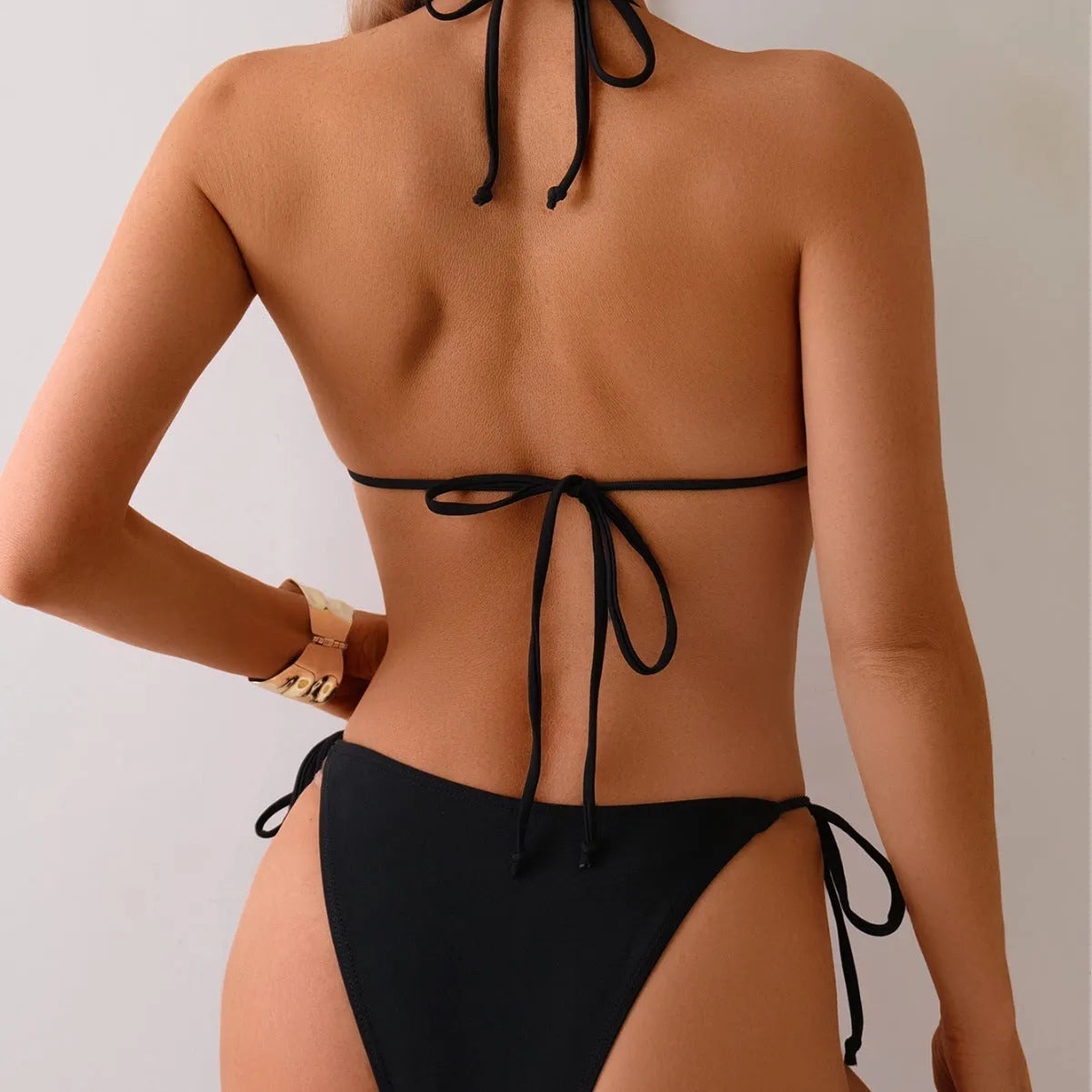 Black women's bikini swimsuit with metal bead detailing on side-split bottoms