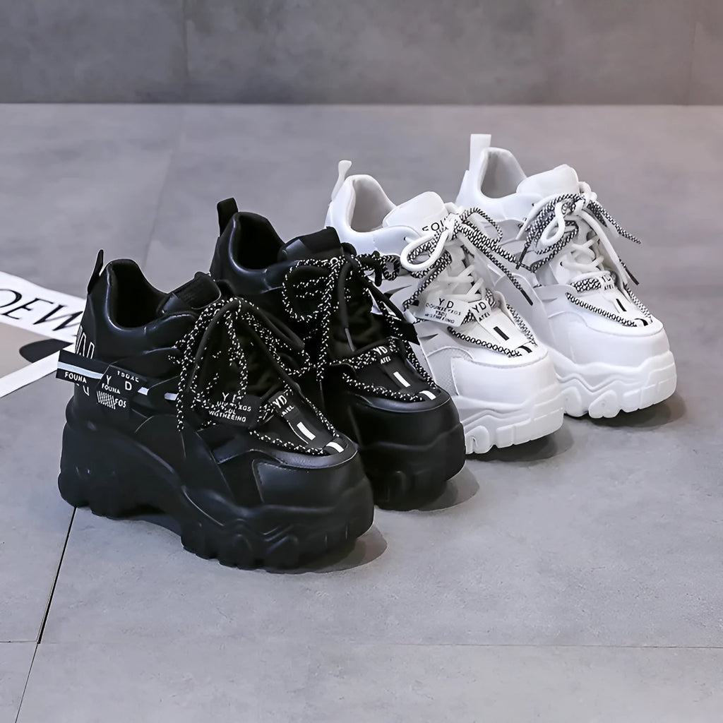 White women's mesh platform tennis shoes with cross strap and a thick rubber sole.