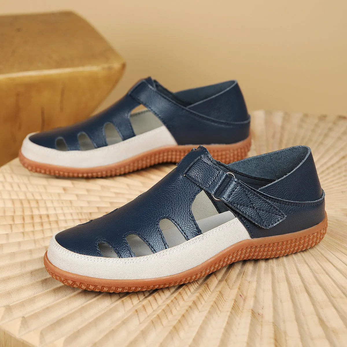 Women's plus size flat sandals in blue with hollow toe cap and breathable design on a thick rubber sole.