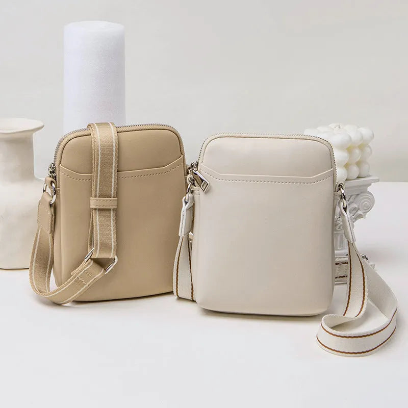 Solid colour small crossbody mobile phone bag in beige, showing front view and adjustable strap.