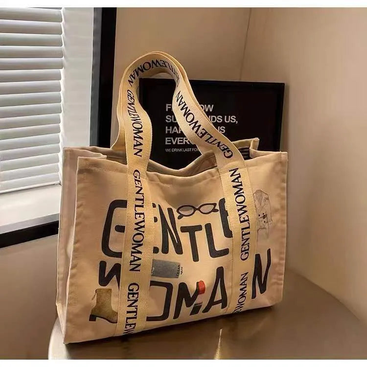 Large canvas women's travel tote bag with print design options including black letters and patterns.