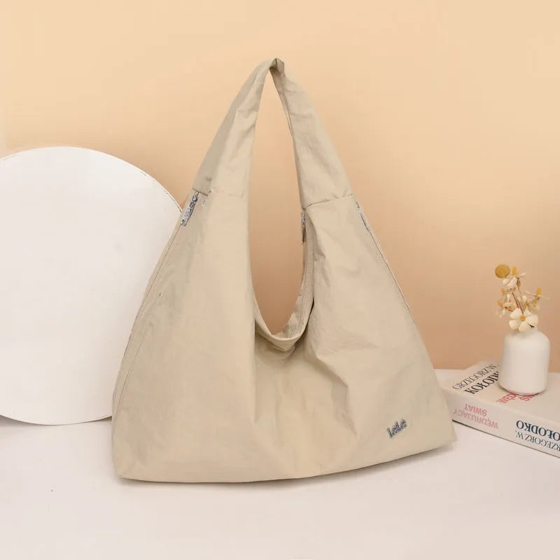 Heart-shaped soft nylon crossbody bag for women in black, blue, khaki, or yellow.