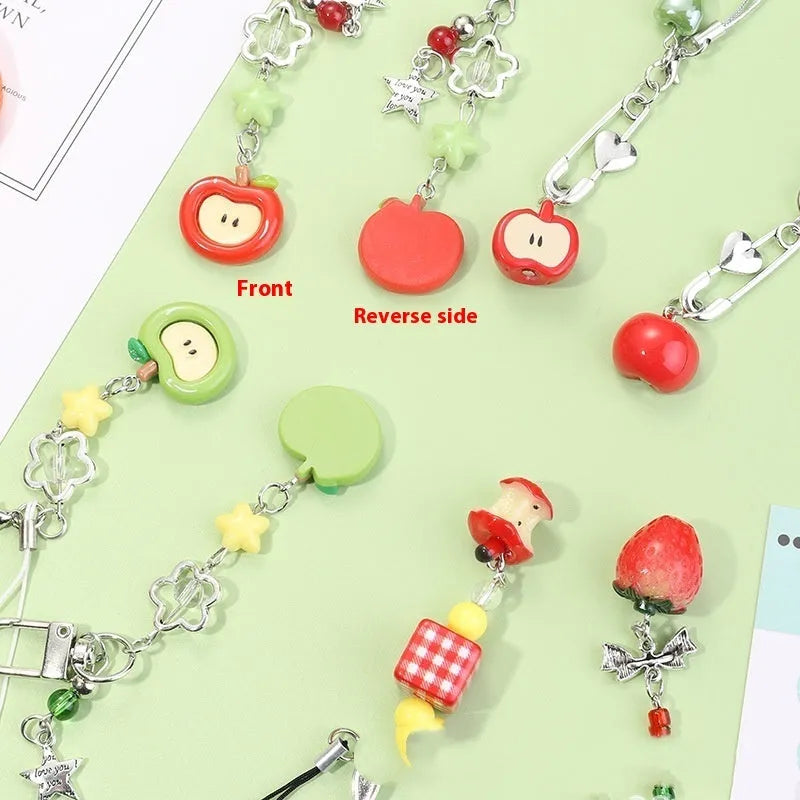 Plastic resin fruit pattern phone charm keychain pendant with apple and strawberry designs on a white rope.