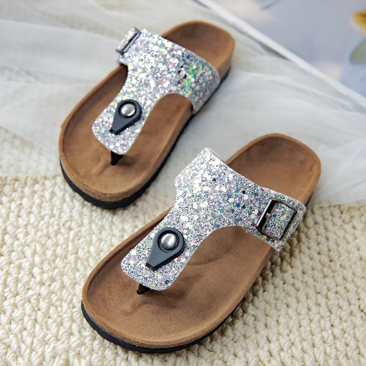 Gold, pink, and silver cork couples flip-flops with artificial leather upper and non-slip sole.