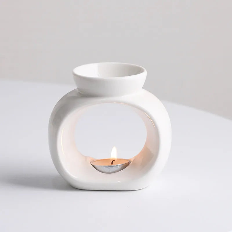 White Nordic style ceramic aromatherapy stove ornament on a table.